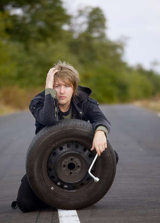 Man with wheel on the roadの写真素材