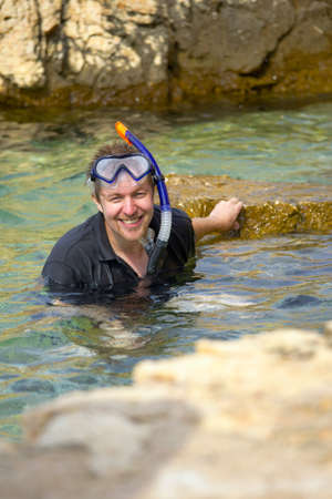 Young man snorkeling happily in the seaの写真素材