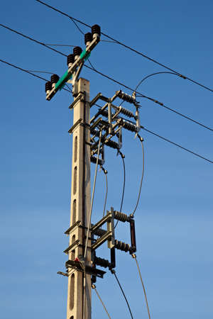 Electric pillar against clear blue skyの写真素材