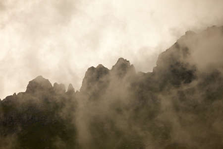 High mountain ridge in thick fogの写真素材