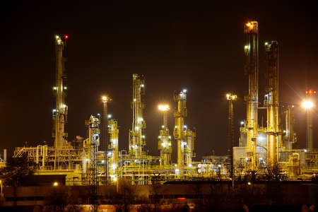 Oil refinery structures at nightの写真素材