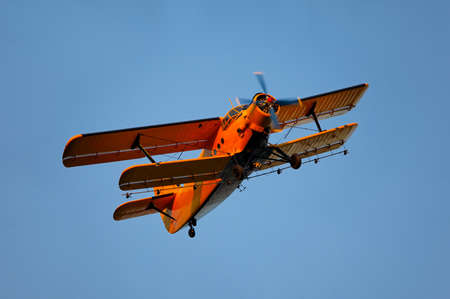 Old airplane against blue skyの写真素材