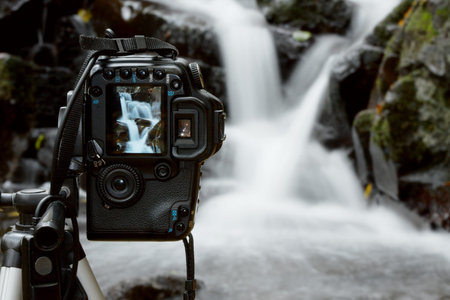 Camera during waterfall shootingの写真素材