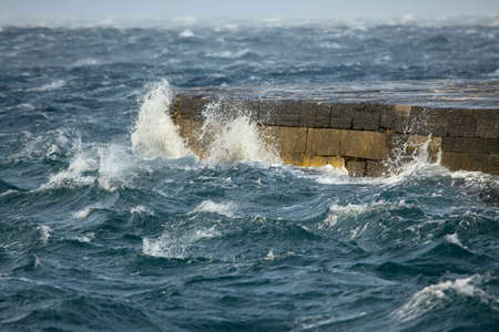 Stormy waves hitting the dockの写真素材