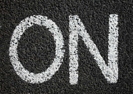 'on' label painted on asphalt surfaceの写真素材