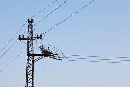 Electric pillar against clear blue skyの写真素材