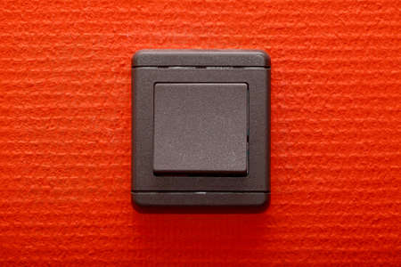 Light switch on a red wallの写真素材