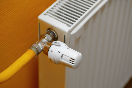 Heating radiator detail against orange wall