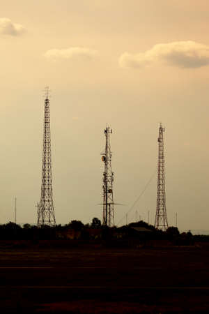 Old radio towers against twilight skyの写真素材