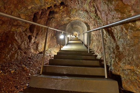 Mining tunnel with lights and railsの写真素材
