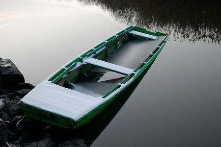 Old boat in winter snowの写真素材