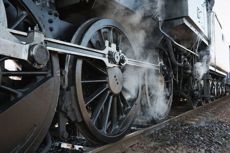 Steam locomotive rolling by closeの写真素材