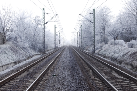 Railroad tracks in winter fogの写真素材