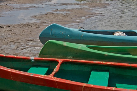 Canoes parked on the riversideの写真素材
