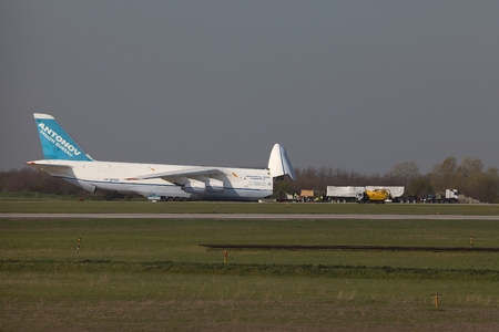 BUDAPEST, HUNGARY - APRIL 16: Antonov An-124 cargo plane at Budapest Airport on April 16, 2013. The aircraft is being loaded by an oversize truck with 100 tons of cargo.のeditorial素材