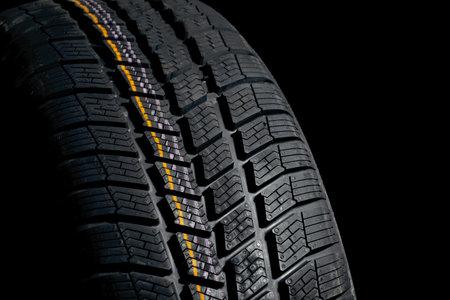 Winter tyre closeup, dark backgroud