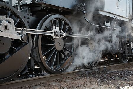 Steam locomotive rolling by closeの写真素材
