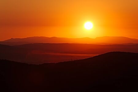 Sunrise over the distant hillsの写真素材