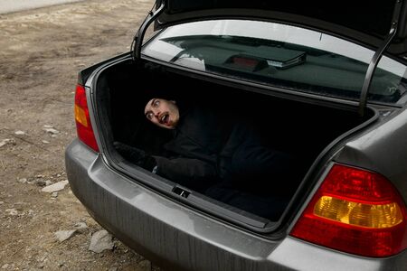 Man in the trunk of a carの写真素材