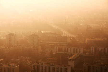Town with twilight glowing in smoky airの写真素材