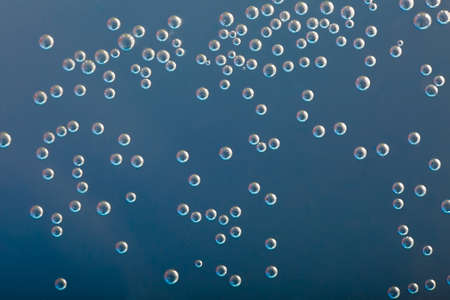 Many small bubbles in water, blue toneの写真素材