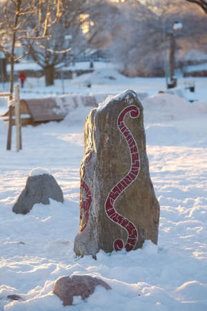 Runestone in a snowy parkの写真素材