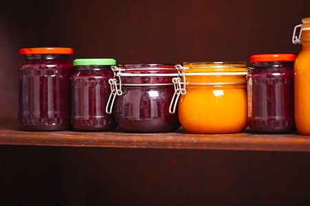 Jars of jam on a shelfの写真素材