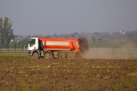 Truck at a road construction site with dust in the airの写真素材
