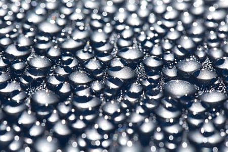 Water drops on a shiny metal surfaceの写真素材