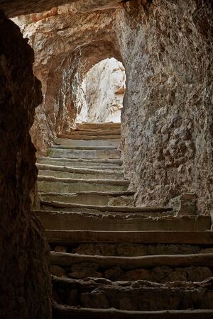 Tunnel in stone wall in the Dolomitesの写真素材