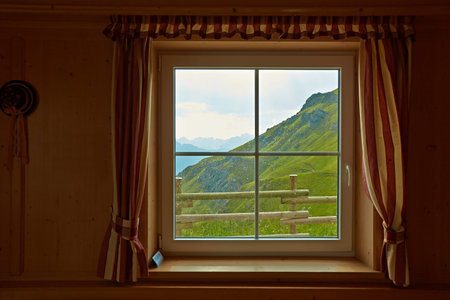 Rain starting on a mountain landscape, looking out the hut window