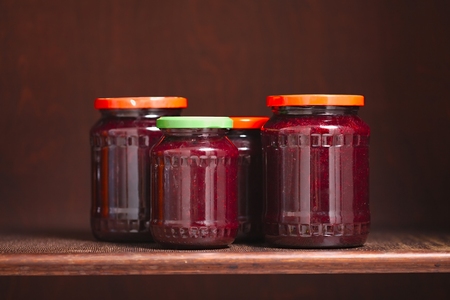 Jars of jam on a shelfの写真素材