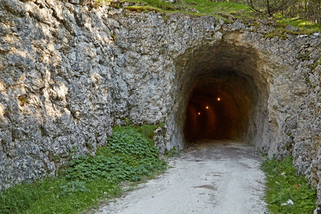 Tunnel in stone wall in the Dolomites