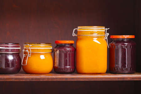 Jars of jam on a shelfの写真素材