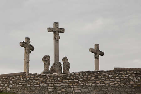 Crosses on the hill in cloudy weatherの写真素材