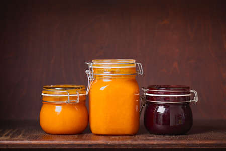 Jars of jam on a shelfの写真素材