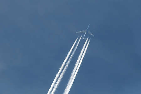 Plane at cruising altitude against blue skyの写真素材