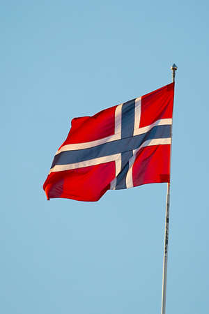 Norwegian flag waving against blue skyの写真素材