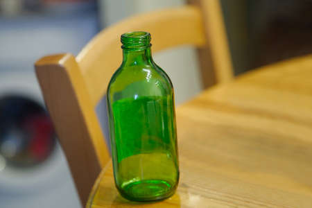 Still life of empty bottle and cables on a tableの写真素材