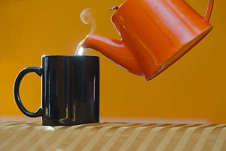 Streaming tea poured in a cupの写真素材