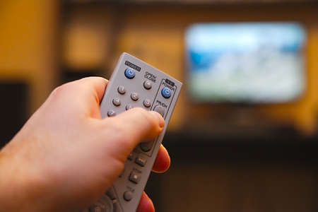 Using remote control for switching programsの写真素材