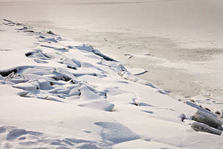 Ice sheets frozen at the lakesideの写真素材
