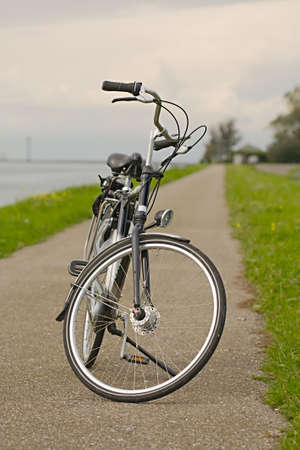 Bicycle on the road along the riverの写真素材