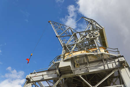 Old crane in a dockの写真素材