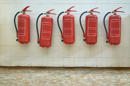 Fire extinguishers on the wallの写真素材