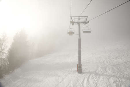 Ski lift in the cloudsの写真素材