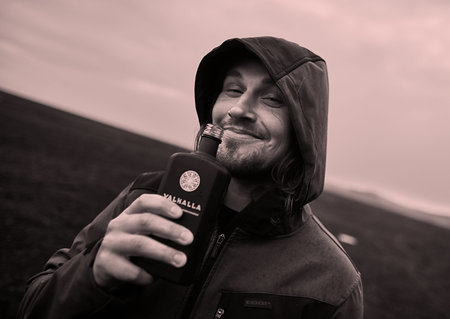 Hooded man drinking in Iceland