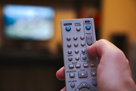 Using remote control for switching programsの写真素材