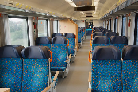 Interior of a passenger train with empty seats