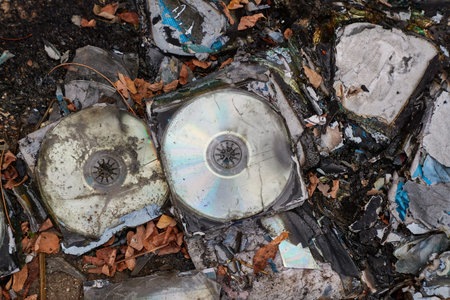 CDs thrown away in garbage dump piles